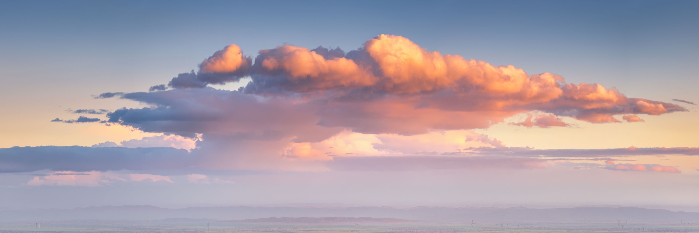 A lit cloud bank over the Shields Valley at sunset
